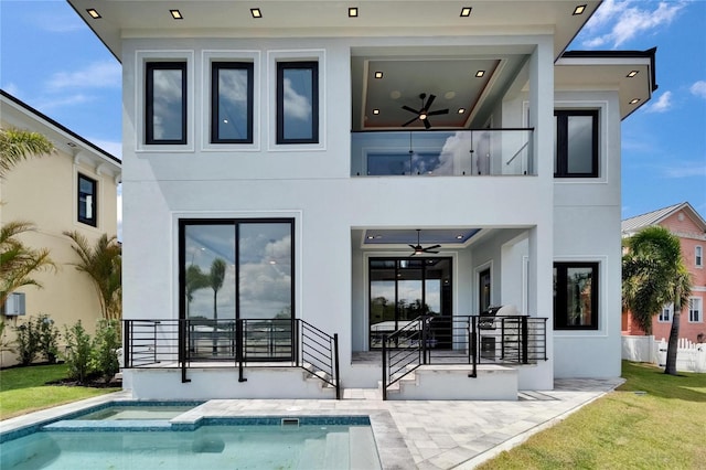 6520 Simone Shores Cir, Apollo Beach, FL 33572 - rear view of house with a balcony, ceiling fan, stucco siding, and an in-ground hot tub