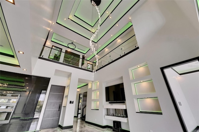 6526 Simone Shores Cir, Apollo Beach, FL 33572 - unfurnished living room with a towering ceiling and baseboards