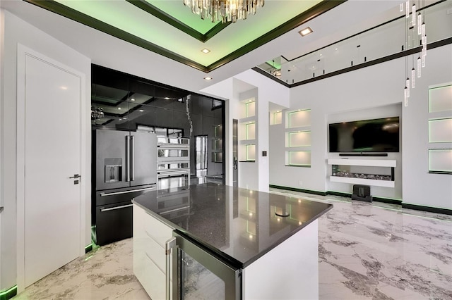 6526 Simone Shores Cir, Apollo Beach, FL 33572 - kitchen featuring appliances with stainless steel finishes, beverage cooler, light marble finish flooring, a chandelier, and built in shelves