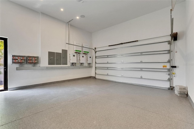 6526 Simone Shores Cir, Apollo Beach, FL 33572 - garage featuring baseboards, electric panel, and recessed lighting