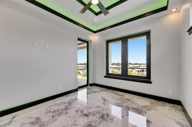 6526 Simone Shores Cir, Apollo Beach, FL 33572 - unfurnished room featuring marble tiled flooring, ceiling fan, baseboards, recessed lighting, and a tray ceiling