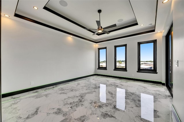 6526 Simone Shores Cir, Apollo Beach, FL 33572 - empty room featuring a tray ceiling, ceiling fan, light marble finish flooring, recessed lighting, and baseboards