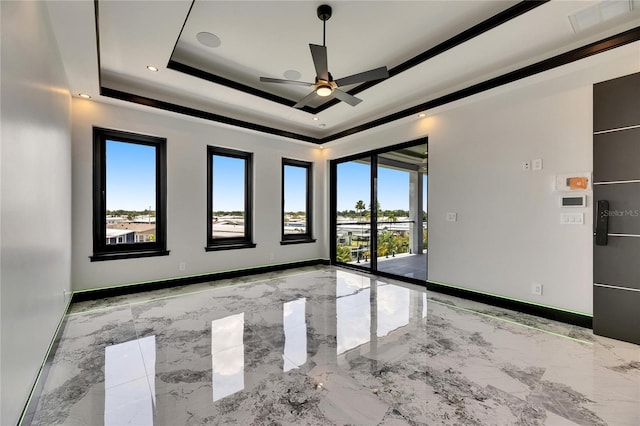 6526 Simone Shores Cir, Apollo Beach, FL 33572 - empty room with healthy amount of natural light, a ceiling fan, a raised ceiling, and light marble finish flooring