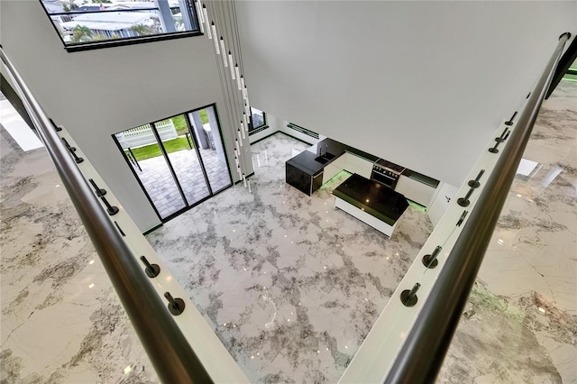 6526 Simone Shores Cir, Apollo Beach, FL 33572 - living area with marble tiled floors, a high ceiling, and a baseboard radiator