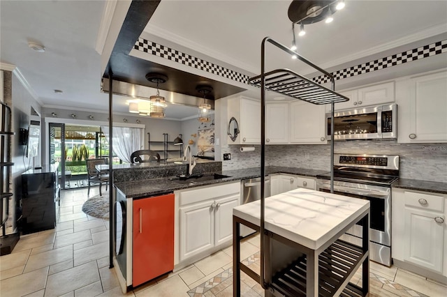 644 Yardarm Dr Unit 22, Apollo Beach, FL 33572 - kitchen featuring appliances with stainless steel finishes, a sink, crown molding, tasteful backsplash, and white cabinets
