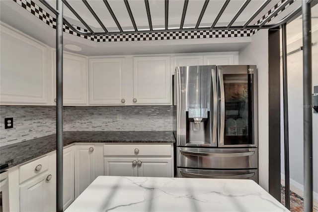 644 Yardarm Dr Unit 22, Apollo Beach, FL 33572 - kitchen with stainless steel refrigerator with ice dispenser, white cabinets, tasteful backsplash, and dark stone counters