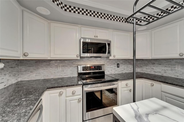 644 Yardarm Dr Unit 22, Apollo Beach, FL 33572 - kitchen featuring stainless steel appliances, white cabinetry, tasteful backsplash, dark stone counters, and crown molding