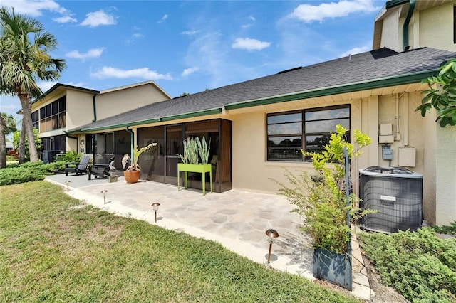 644 Yardarm Dr Unit 22, Apollo Beach, FL 33572 - back of house with central AC, a yard, a sunroom, a patio area, and stucco siding