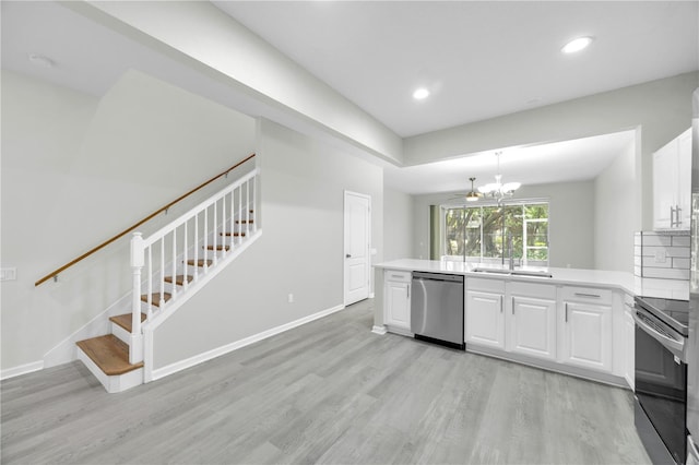 4910 Chatham Gate Drive Dr, Riverview, FL 33578 - kitchen featuring appliances with stainless steel finishes, light wood-style floors, a sink, white cabinets, and recessed lighting