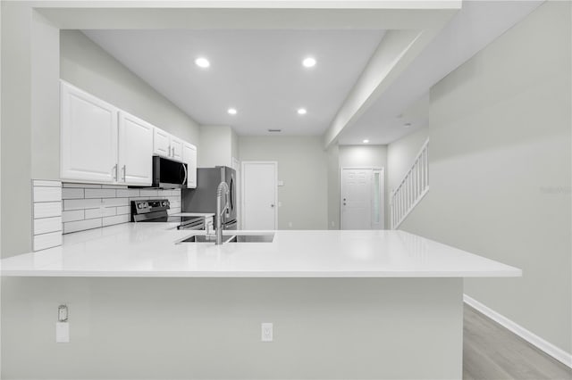 4910 Chatham Gate Drive Dr, Riverview, FL 33578 - kitchen with stainless steel electric range, a peninsula, backsplash, light countertops, and recessed lighting