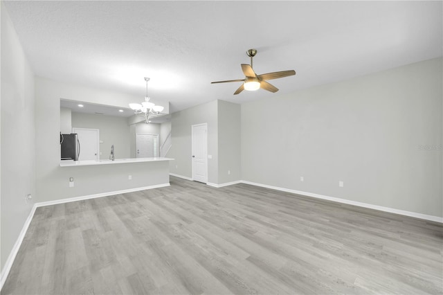 4910 Chatham Gate Drive Dr, Riverview, FL 33578 - unfurnished living room featuring a sink, baseboards, light wood finished floors, a chandelier, and recessed lighting