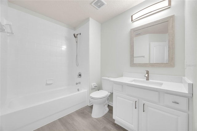 4910 Chatham Gate Drive Dr, Riverview, FL 33578 - bathroom featuring vanity, wood finished floors, toilet, tub / shower combination, and a textured ceiling