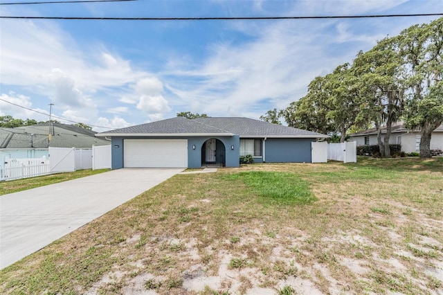 5540 Applegate Dr, Spring Hill, FL 34606 - ranch-style home with a gate, concrete driveway, a garage, and stucco siding