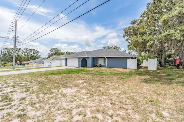 5540 Applegate Dr, Spring Hill, FL 34606 - ranch-style home with driveway, a gate, an attached garage, and stucco siding