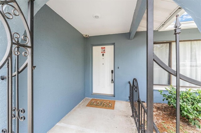 5540 Applegate Dr, Spring Hill, FL 34606 - property entrance with stucco siding and a security system