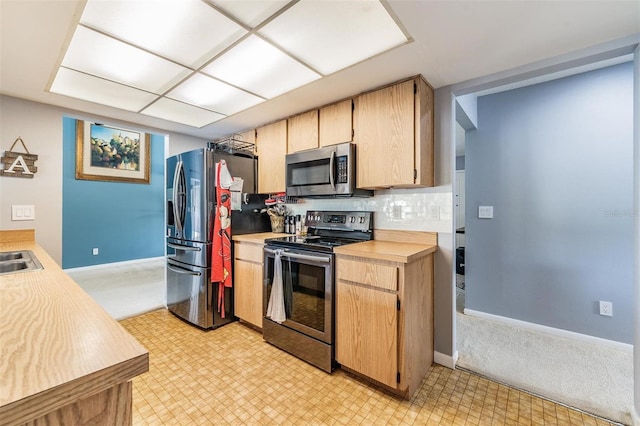 5540 Applegate Dr, Spring Hill, FL 34606 - kitchen with appliances with stainless steel finishes, light countertops, light floors, baseboards, and decorative backsplash