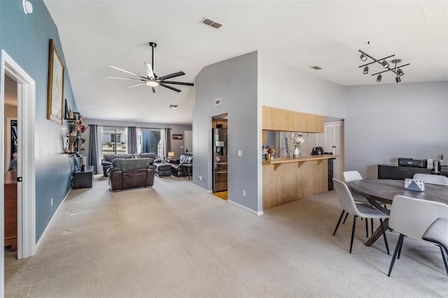 5540 Applegate Dr, Spring Hill, FL 34606 - dining area featuring ceiling fan, light colored carpet, vaulted ceiling, and baseboards