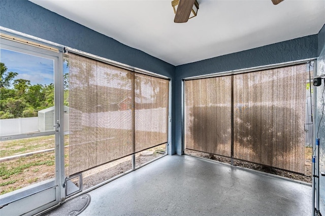 5540 Applegate Dr, Spring Hill, FL 34606 - unfurnished sunroom featuring plenty of natural light and a ceiling fan