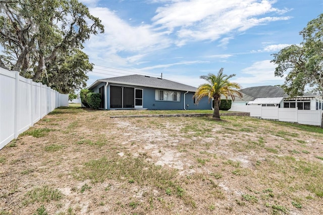 5540 Applegate Dr, Spring Hill, FL 34606 - rear view of property with a sunroom