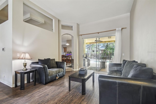6918 Potomac Cir, Riverview, FL 33578 - living area featuring dark wood finished floors, arched walkways, and baseboards