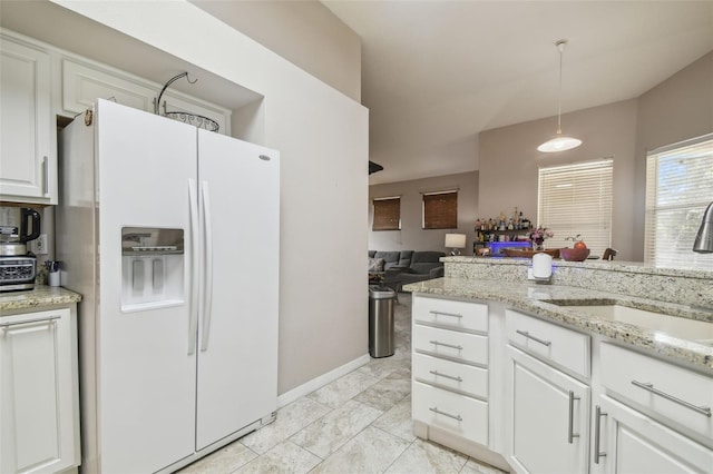 6918 Potomac Cir, Riverview, FL 33578 - kitchen with white fridge with ice dispenser, white cabinetry, decorative light fixtures, a sink, and open floor plan