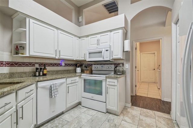 6918 Potomac Cir, Riverview, FL 33578 - kitchen with white appliances, white cabinetry, open shelves, and backsplash
