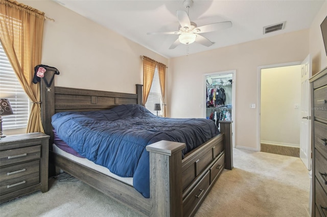 6918 Potomac Cir, Riverview, FL 33578 - bedroom featuring light carpet, a spacious closet, ceiling fan, baseboards, and a closet