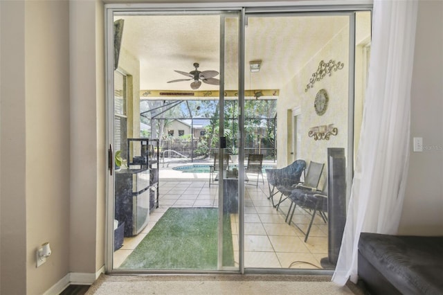6918 Potomac Cir, Riverview, FL 33578 - doorway featuring a ceiling fan, a sunroom, tile patterned flooring, and baseboards