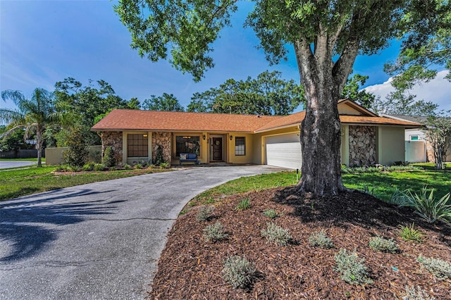 3041 Oak View Dr, Palm Harbor, FL 34684 - ranch-style house featuring stone siding, a garage, and concrete driveway