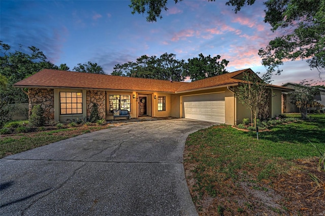 3041 Oak View Dr, Palm Harbor, FL 34684 - ranch-style home featuring a garage, driveway, stucco siding, and a front lawn