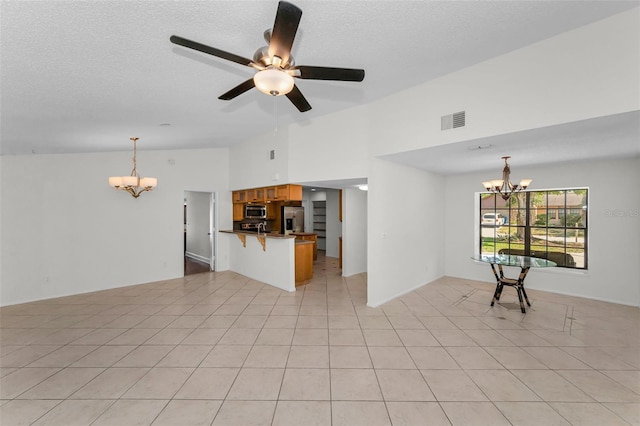 3041 Oak View Dr, Palm Harbor, FL 34684 - unfurnished living room featuring a chandelier, a textured ceiling, light tile patterned floors, high vaulted ceiling, and ceiling fan