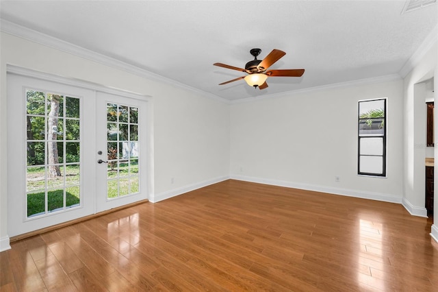 3041 Oak View Dr, Palm Harbor, FL 34684 - empty room featuring a ceiling fan, french doors, baseboards, wood finished floors, and crown molding