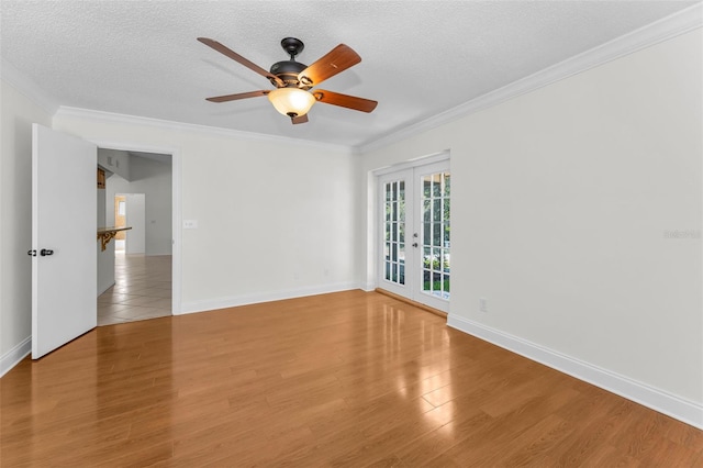 3041 Oak View Dr, Palm Harbor, FL 34684 - unfurnished room featuring a ceiling fan, french doors, wood finished floors, a textured ceiling, and ornamental molding