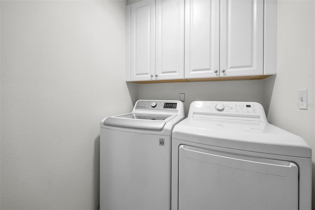 3041 Oak View Dr, Palm Harbor, FL 34684 - laundry room featuring washer and dryer and cabinet space