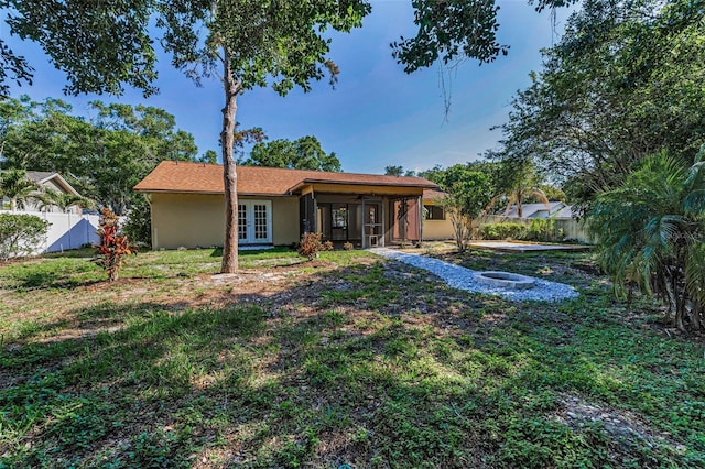 3041 Oak View Dr, Palm Harbor, FL 34684 - rear view of property featuring french doors, an outdoor fire pit, stucco siding, ceiling fan, and a sunroom
