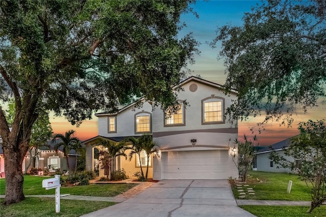 8518 Tidal Bay Ln, Tampa, FL 33635 - mediterranean / spanish-style house featuring a garage, driveway, a front lawn, and stucco siding