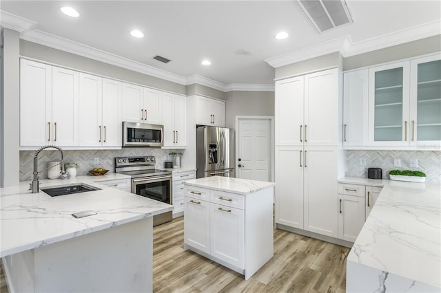 8518 Tidal Bay Ln, Tampa, FL 33635 - kitchen with stainless steel appliances, a sink, tasteful backsplash, light stone countertops, and white cabinetry