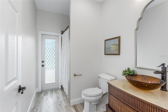 8518 Tidal Bay Ln, Tampa, FL 33635 - bathroom with toilet, baseboards, vanity, and wood finished floors