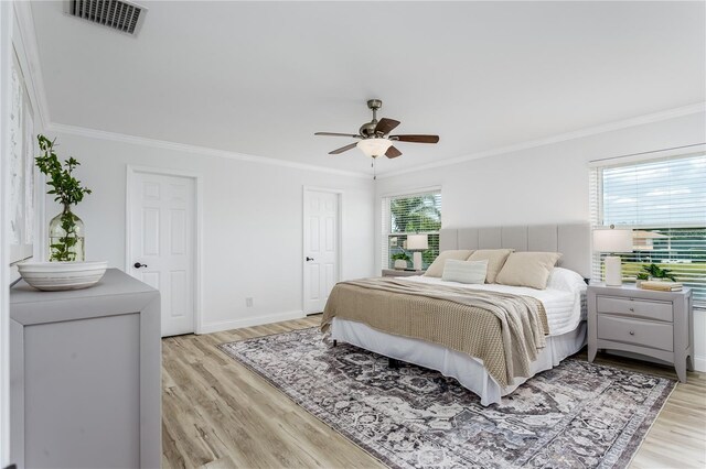 8518 Tidal Bay Ln, Tampa, FL 33635 - bedroom with light wood-style flooring, crown molding, a ceiling fan, and baseboards