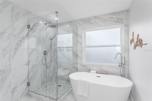 8518 Tidal Bay Ln, Tampa, FL 33635 - full bathroom featuring a marble finish shower, a freestanding tub, marble finish flooring, and tile walls