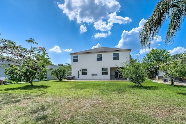 8518 Tidal Bay Ln, Tampa, FL 33635 - rear view of property with central AC, stucco siding, and a lawn
