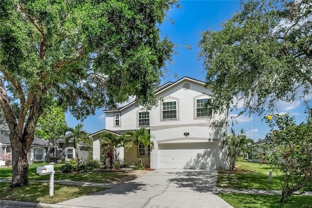 8518 Tidal Bay Ln, Tampa, FL 33635 - traditional home with a garage, stucco siding, concrete driveway, and a front lawn