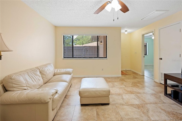 8436 60th St N Unit 304, Pinellas Park, FL 33781 - living room featuring ceiling fan, a textured ceiling, and baseboards