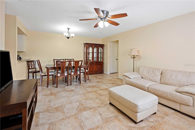 8436 60th St N Unit 304, Pinellas Park, FL 33781 - living room with ceiling fan, baseboards, a textured ceiling, light stone finish floors, and a chandelier