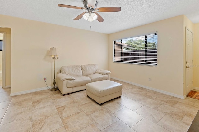 8436 60th St N Unit 304, Pinellas Park, FL 33781 - living area with a textured ceiling, ceiling fan, and baseboards