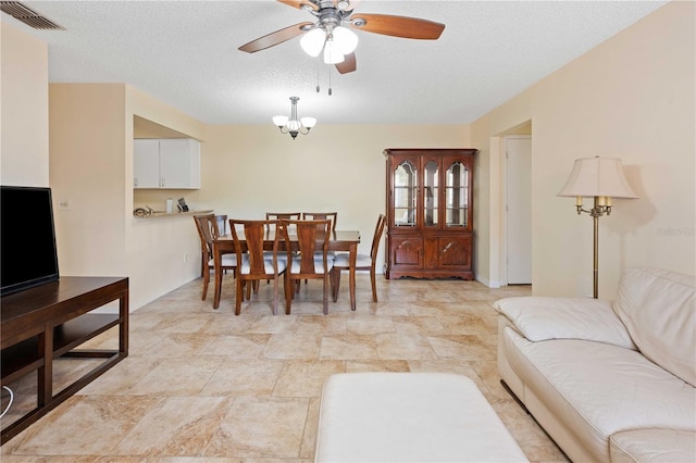 8436 60th St N Unit 304, Pinellas Park, FL 33781 - living area featuring a ceiling fan, a textured ceiling, baseboards, and light stone finish floors