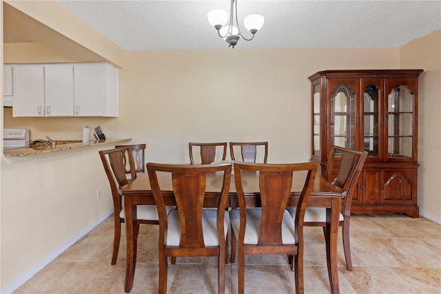 8436 60th St N Unit 304, Pinellas Park, FL 33781 - dining room with a textured ceiling and baseboards