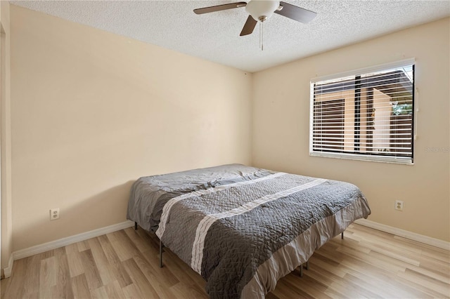 8436 60th St N Unit 304, Pinellas Park, FL 33781 - bedroom with wood finished floors, a textured ceiling, baseboards, and ceiling fan