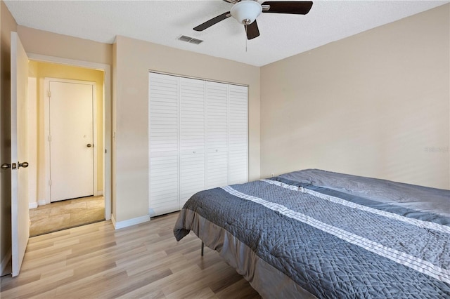 8436 60th St N Unit 304, Pinellas Park, FL 33781 - bedroom featuring light wood finished floors, a closet, a ceiling fan, and baseboards
