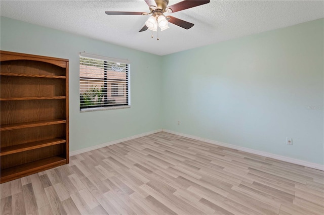 8436 60th St N Unit 304, Pinellas Park, FL 33781 - empty room featuring wood finished floors, a textured ceiling, a ceiling fan, and baseboards